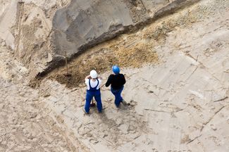 Zwei Mitarbeitende machen eine Prüfbegehung auf einer Baustelle