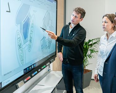 Mitarbeitende bei Lindschulte in Nordhorn besprechen eine Planung am digitalen Whiteboard